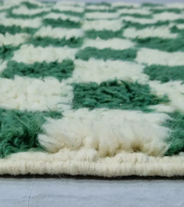 Zoomed In View of Handmade Moroccan plush wool rug with a green and white checkered pattern