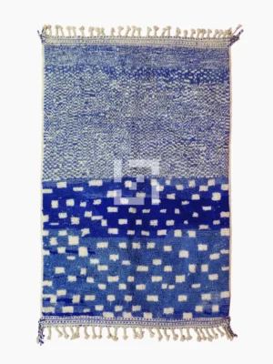 Top View of Handwoven wool rug with a checked abstract pattern on a blue background
