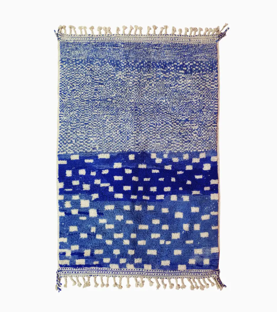 Top View of Handwoven wool rug with a checked abstract pattern on a blue background