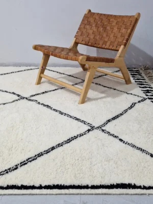 Ivory Hand-knotted Beni Ourain Moroccan wool rug with a Black diamond lattice pattern in wall decorated room