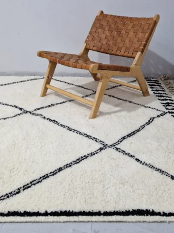 Ivory Hand-knotted Beni Ourain Moroccan wool rug with a Black diamond lattice pattern in wall decorated room
