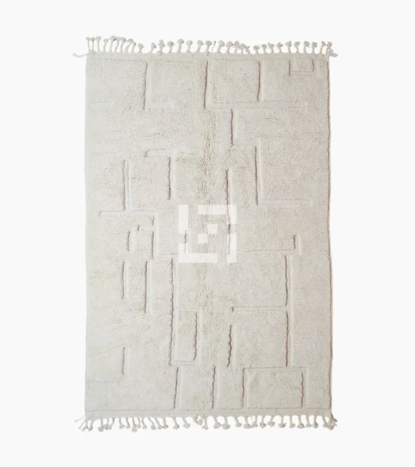 Moroccan hand-knotted ivory wool rug with raised geometric pattern and tassels