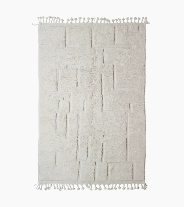 Moroccan hand-knotted ivory wool rug with raised geometric pattern and tassels