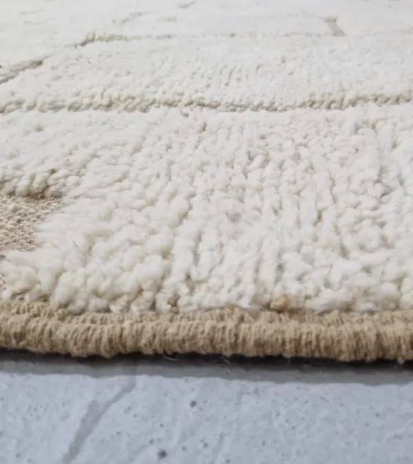 Zoomed In View of Neutral Handmade Moroccan high-low wool rug with a geometric pattern