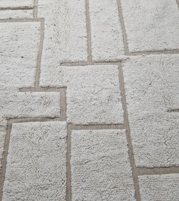 Detailed View of Neutral Handmade Moroccan high-low wool rug with a geometric pattern