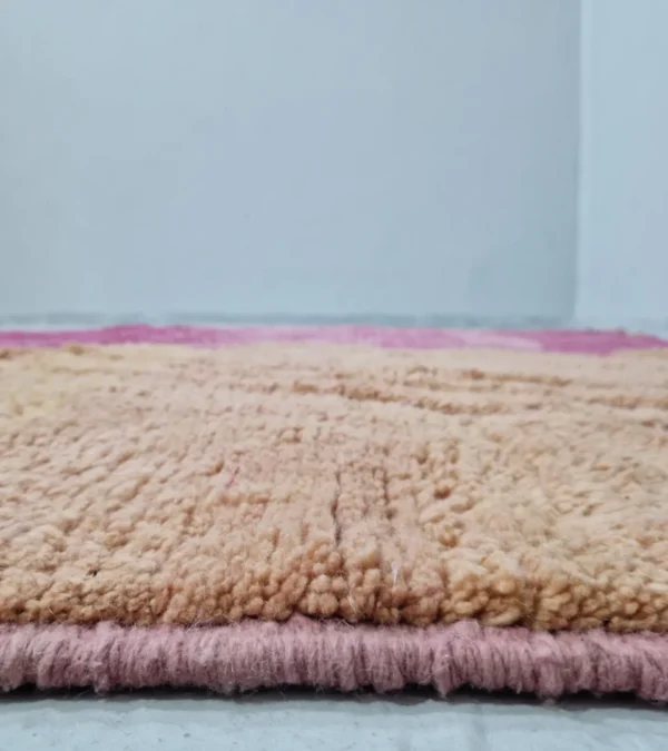 Zoomed In View of Detailed View of Handmade Moroccan Solari wool rug with fuchsia and beige zigzag design and geometric diamond pattern
