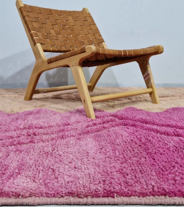 Handmade Moroccan Solari wool rug with fuchsia and beige zigzag design and geometric diamond pattern in room