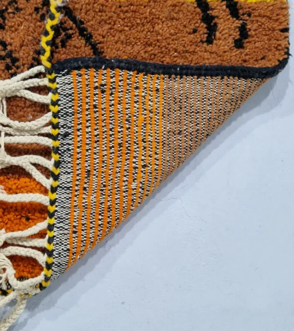 Detailed View of Handwoven tribal wool rug with an abstract color-block pattern