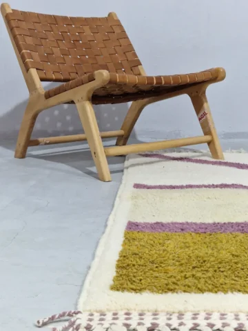 Off-White and Purple Curve Abstract Wool Rug Styled in a wall decorated room