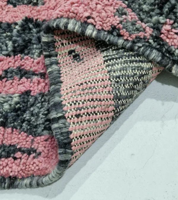 Detailed View of Handmade Moroccan wool rug with an abstract striped design in rose pink and charcoal