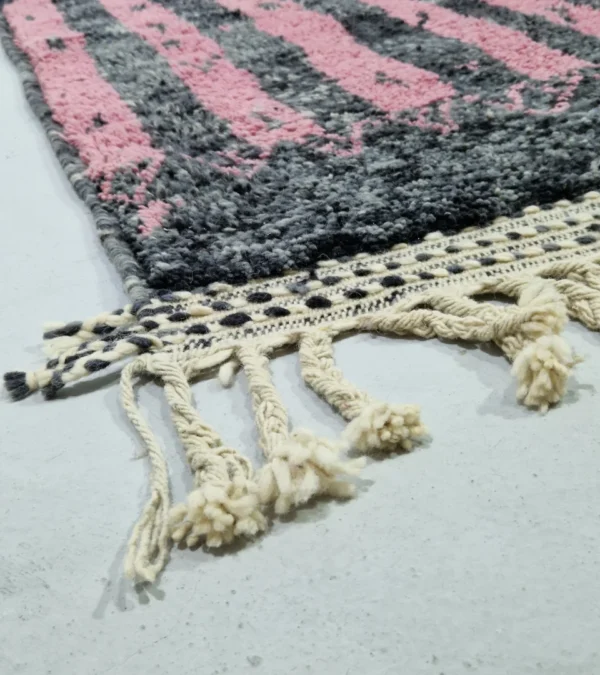 Detailed View of Handmade Moroccan wool rug with an abstract striped design in rose pink and charcoal