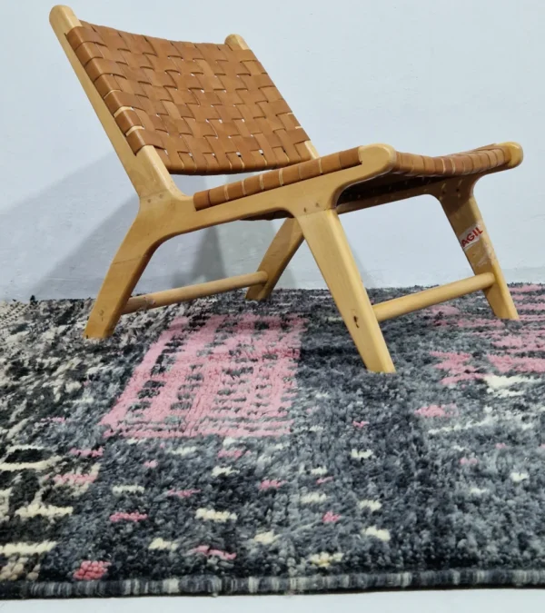 Handmade Moroccan wool rug with an abstract striped design in rose pink and charcoal in room