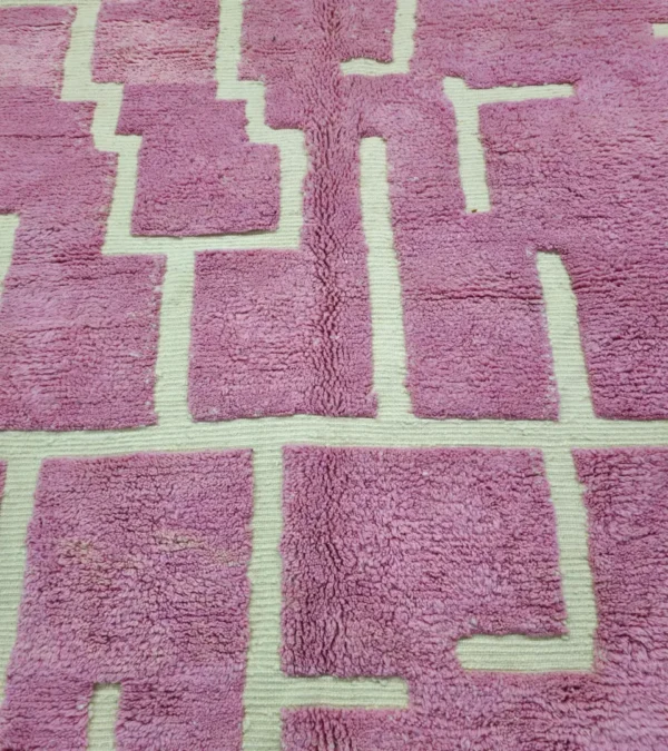 Detailed View of Aivra handmade Beni Ourain wool rug with a minimalist pink and ivory labyrinth design