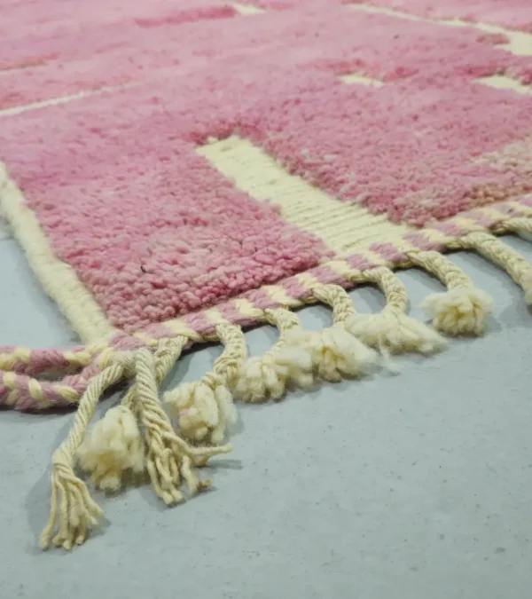 Detailed View of Aivra handmade Beni Ourain wool rug with a minimalist pink and ivory labyrinth design