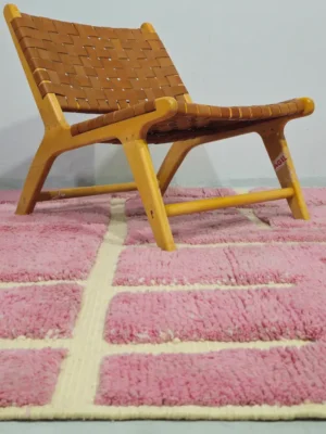 Aivra handmade Beni Ourain wool rug with a minimalist pink and ivory labyrinth design in room