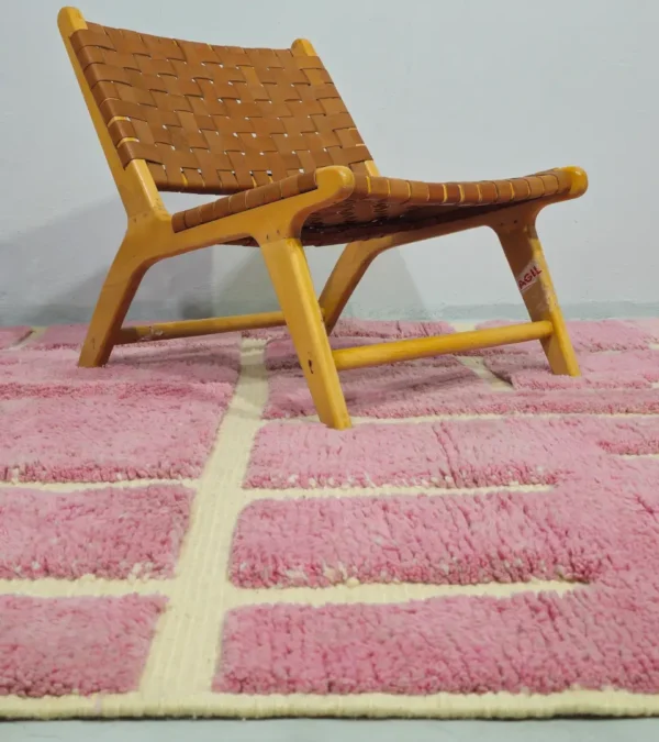 Aivra handmade Beni Ourain wool rug with a minimalist pink and ivory labyrinth design in room