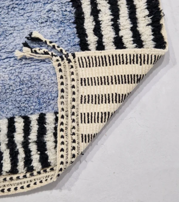Detailed View of Handmade Moroccan wool rug with a minimalist block and stripe design in blue, black, and white
