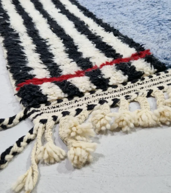 Detailed View of Handmade Moroccan wool rug with a minimalist block and stripe design in blue, black, and white
