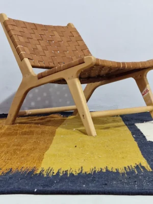 Alice handmade Kilim flatweave rug with a boho geometric design in navy, yellow, brown, and white in room