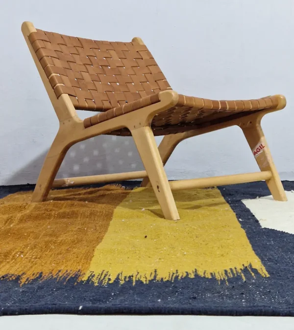 Alice handmade Kilim flatweave rug with a boho geometric design in navy, yellow, brown, and white in room