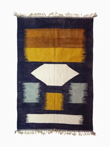 Top View of Alice handmade Kilim flatweave rug with a boho geometric design in navy, yellow, brown, and white