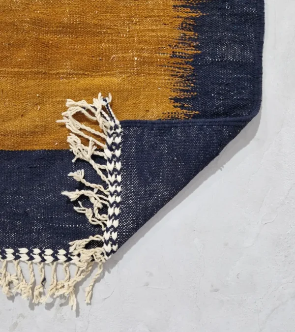 Detailed View of Alice handmade Kilim flatweave rug with a boho geometric design in navy, yellow, brown, and white