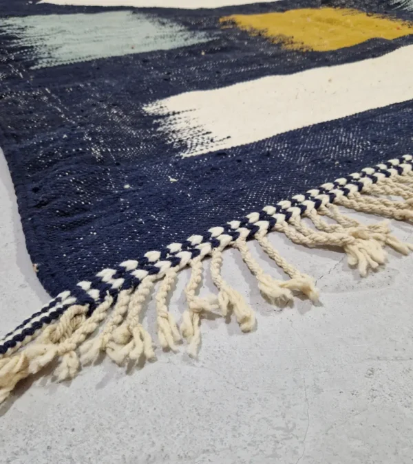 Detailed View of Alice handmade Kilim flatweave rug with a boho geometric design in navy, yellow, brown, and white