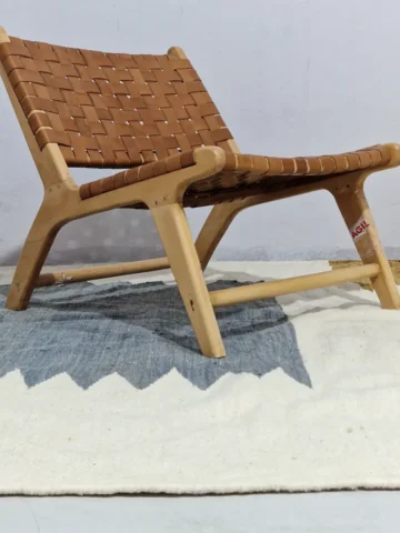 Aline handmade Beni Ourain flatweave rug with a modern jagged pattern in blue, brown, and ivory in room