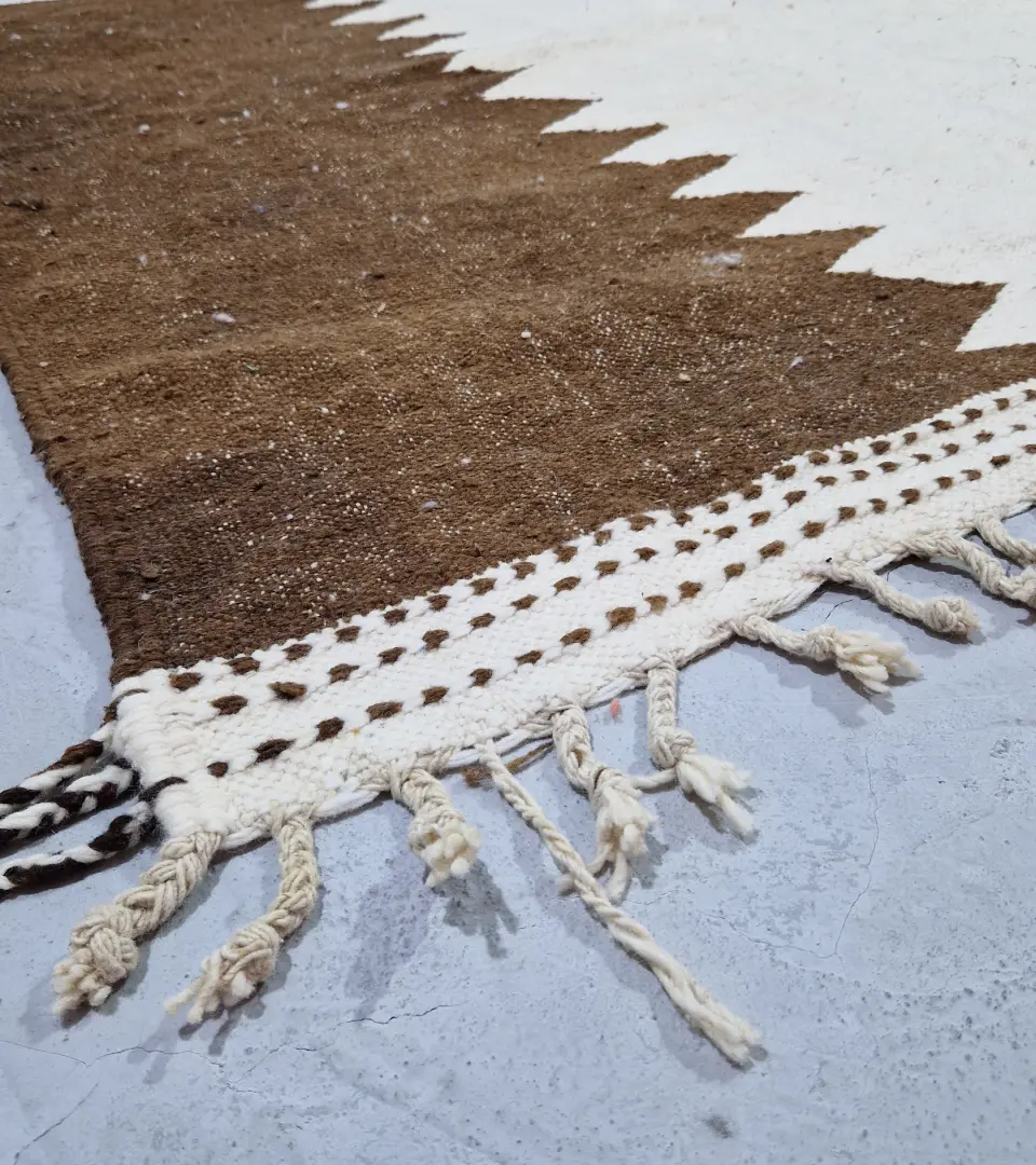 Detailed View of Aline handmade Beni Ourain flatweave rug with a modern jagged pattern in blue, brown, and ivory