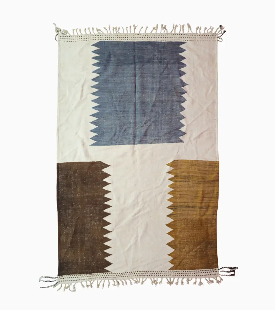 Top View of Aline handmade Beni Ourain flatweave rug with a modern jagged pattern in blue, brown, and ivory