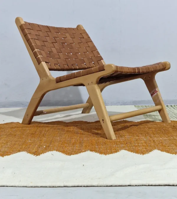 Aline handmade Kilim flatweave rug with a sawtooth pattern in brown, light green, and ivory in room