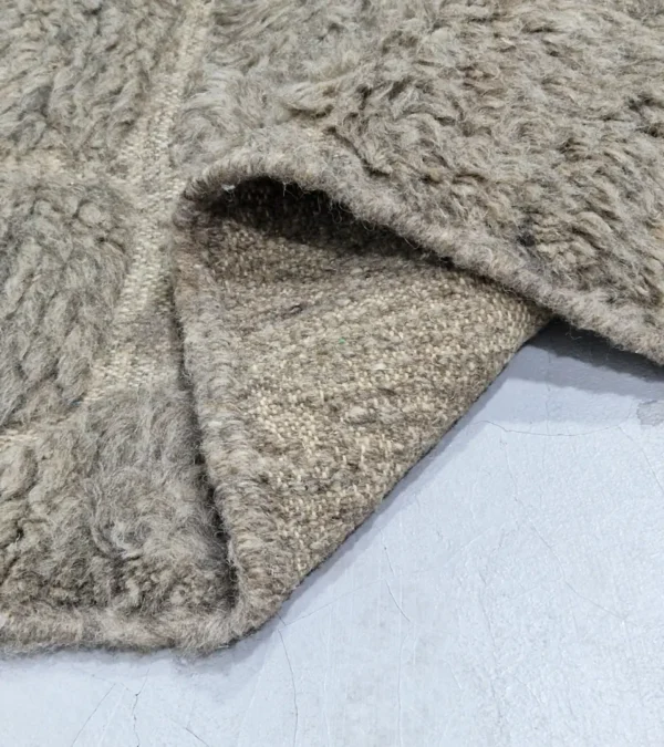 Detailed View of Anis handmade Beni Ourain wool rug with an abstract map-like design in textured taupe and ivory