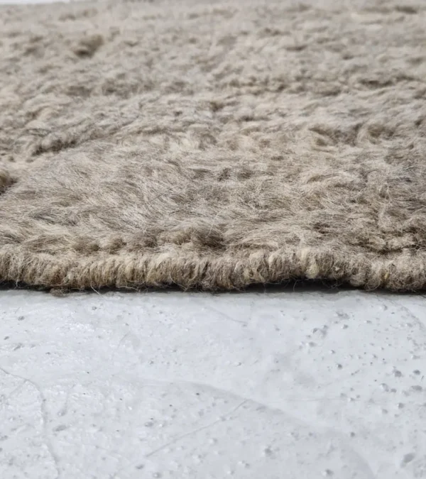 Zoomed View of Anis handmade Beni Ourain wool rug with an abstract map-like design in textured taupe and ivory