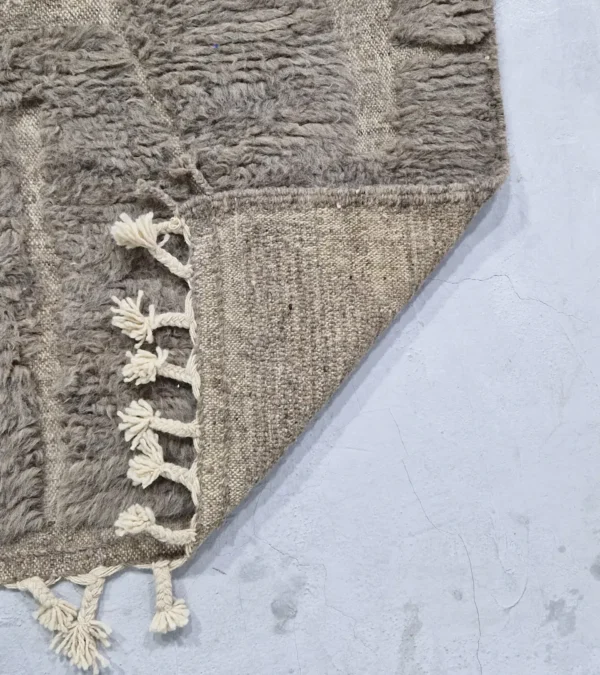 Detailed View of Anis handmade Beni Ourain wool rug with an abstract map-like design in textured taupe and ivory
