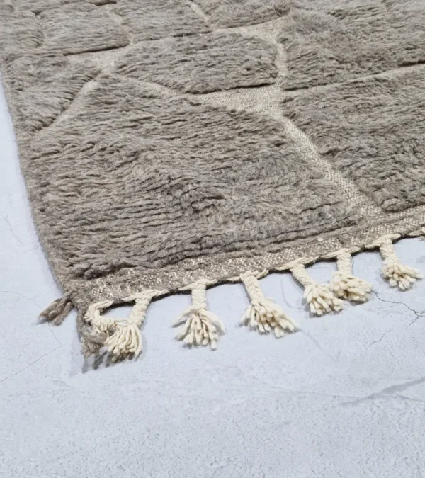 Detailed View of Anis handmade Beni Ourain wool rug with an abstract map-like design in textured taupe and ivory