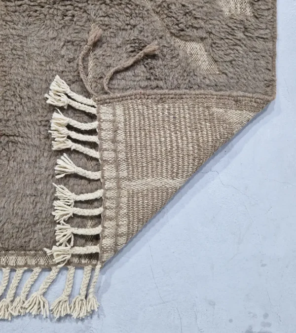 Detailed View of Anis handmade Beni Ourain wool rug with a subtle abstract geometric design in textured taupe and ivory