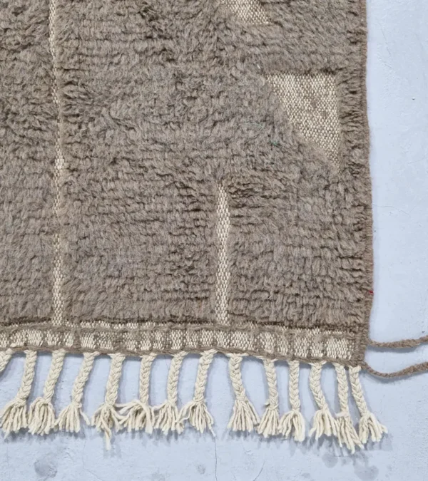 Detailed View of Anis handmade Beni Ourain wool rug with a subtle abstract geometric design in textured taupe and ivory