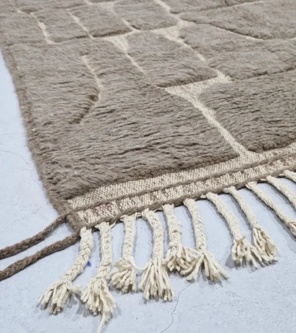 Detailed View of Anis handmade Beni Ourain wool rug with a subtle abstract geometric design in textured taupe and ivory