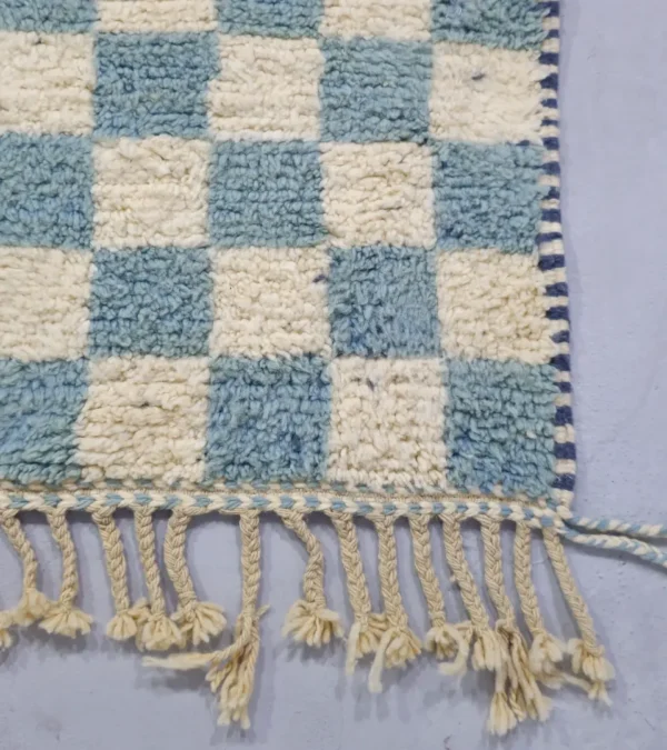 Detailed View of Aura handmade Beni Ourain wool rug with a modern blue and ivory checkerboard design