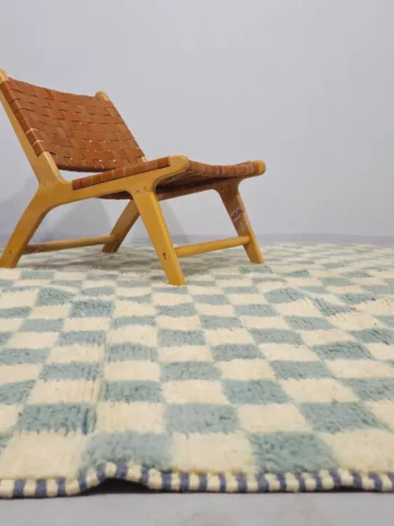 Aura handmade Beni Ourain wool rug with a modern blue and ivory checkerboard design in room