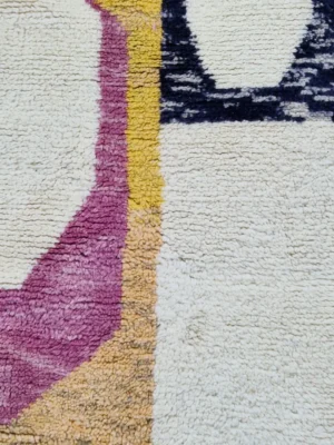 Detailed View of Avery handmade Azilal wool runner with a mid-century abstract design in coral, yellow, blue, and black