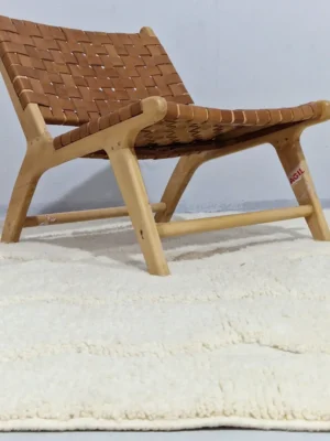 Berry handmade Beni Mrirt wool rug with a subtle raised geometric pattern on an ivory background in room