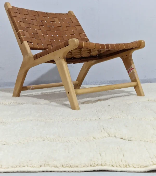 Berry handmade Beni Mrirt wool rug with a subtle raised geometric pattern on an ivory background in room