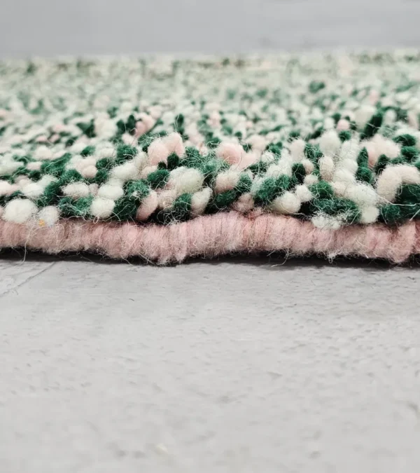 Zoomed In View of Handmade Moroccan wool rug with a high/low pile and a green textured lattice pattern