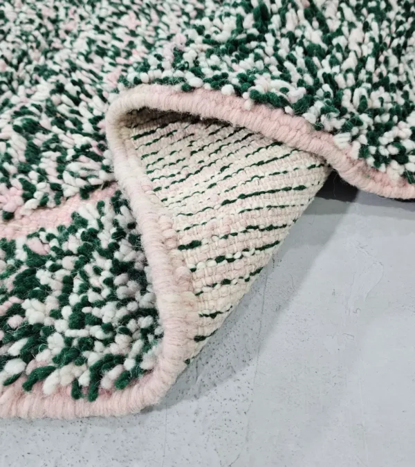 Detailed View of Handmade Moroccan wool rug with a high/low pile and a green textured lattice pattern