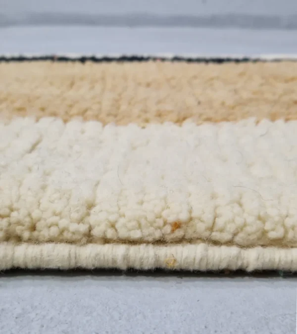 Zoomed In View of Brann handmade Beni Ourain wool runner with a striped and block design in black, beige, and ivory