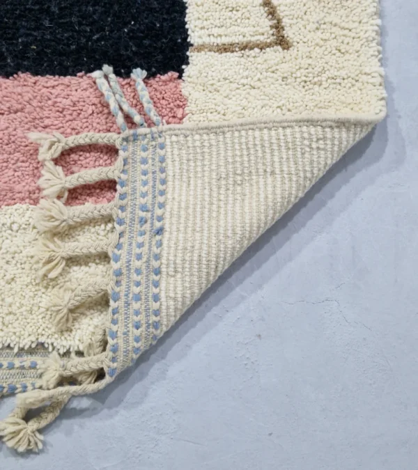 Detailed View of Handmade Moroccan wool rug with a Mid-Century abstract design in teal, brown, pink, and black