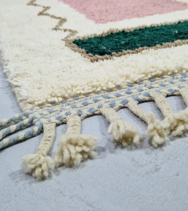 Detailed View of Handmade Moroccan wool rug with a Mid-Century abstract design in teal, brown, pink, and black