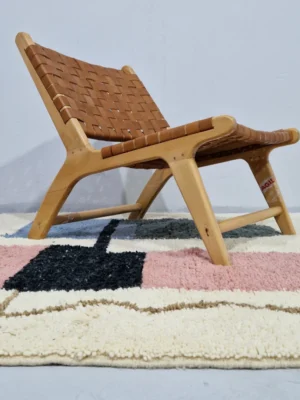 Handmade Moroccan wool rug with a Mid-Century abstract design in teal, brown, pink, and black in room