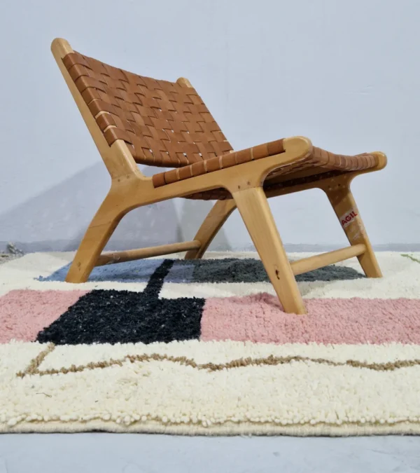 Handmade Moroccan wool rug with a Mid-Century abstract design in teal, brown, pink, and black in room